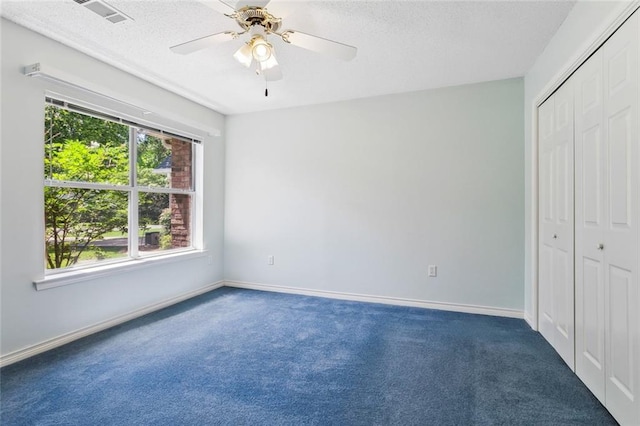 768 Wilkinson St, Mandeville, LA 70448 - unfurnished bedroom with carpet flooring, a textured ceiling, a closet, baseboards, and a ceiling fan
