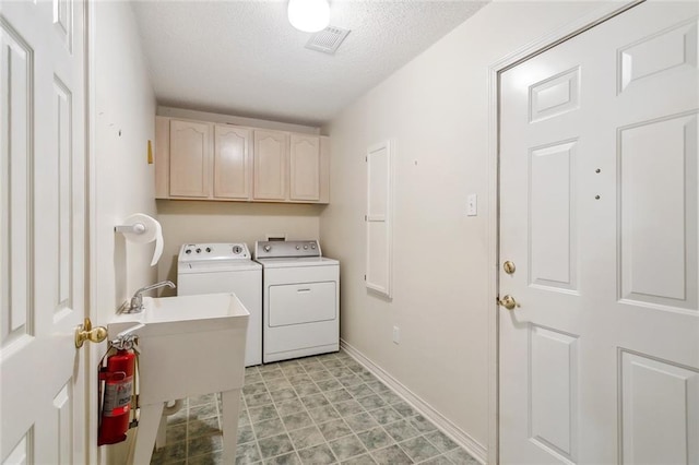 768 Wilkinson St, Mandeville, LA 70448 - laundry room with independent washer and dryer, cabinet space, a textured ceiling, and baseboards