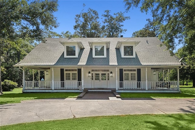 114 Kendrick Dr, Slidell, LA 70461 - view of front facade with covered porch, a shingled roof, a front lawn, and french doors