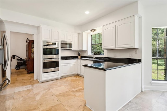 114 Kendrick Dr, Slidell, LA 70461 - kitchen featuring appliances with stainless steel finishes, white cabinets, healthy amount of natural light, and recessed lighting