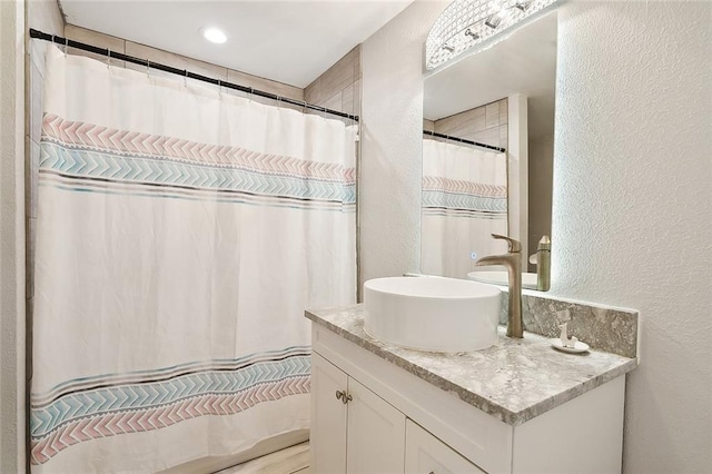 114 Kendrick Dr, Slidell, LA 70461 - full bath featuring a textured wall, vanity, and a shower with curtain