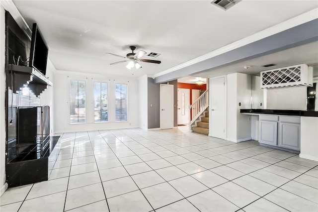 3500 Silver Maple Ct, New Orleans, LA 70131 - unfurnished living room featuring ceiling fan, stairway, light tile patterned floors, baseboards, and ornamental molding