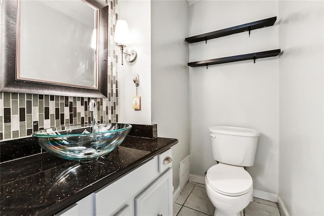 3500 Silver Maple Ct, New Orleans, LA 70131 - bathroom with toilet, vanity, decorative backsplash, baseboards, and tile patterned flooring