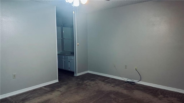 1217 Olde Oaks Dr, Westwego, LA 70094 - unfurnished room with dark colored carpet, baseboards, a ceiling fan, and a textured ceiling