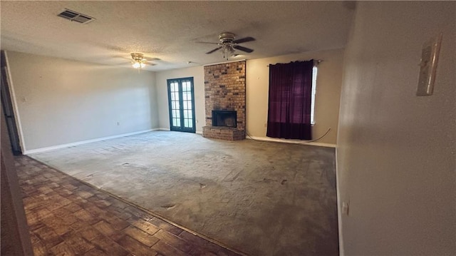 1217 Olde Oaks Dr, Westwego, LA 70094 - unfurnished living room featuring a ceiling fan, a fireplace, a textured ceiling, carpet flooring, and baseboards