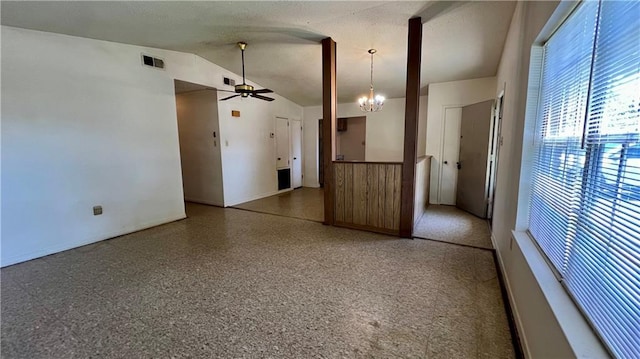 365 Cottage Ct, La Place, LA 70068 - unfurnished room with a ceiling fan, baseboards, lofted ceiling, a wainscoted wall, and a chandelier