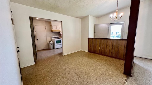 365 Cottage Ct, La Place, LA 70068 - empty room featuring a chandelier, baseboards, and a textured ceiling