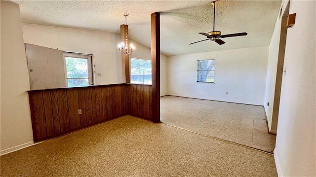 365 Cottage Ct, La Place, LA 70068 - spare room with a textured ceiling, ceiling fan, a chandelier, wainscoting, and lofted ceiling