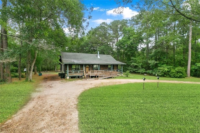 138 Ned Ave, Slidell, LA 70460 - log cabin featuring covered porch, a front yard, and dirt driveway