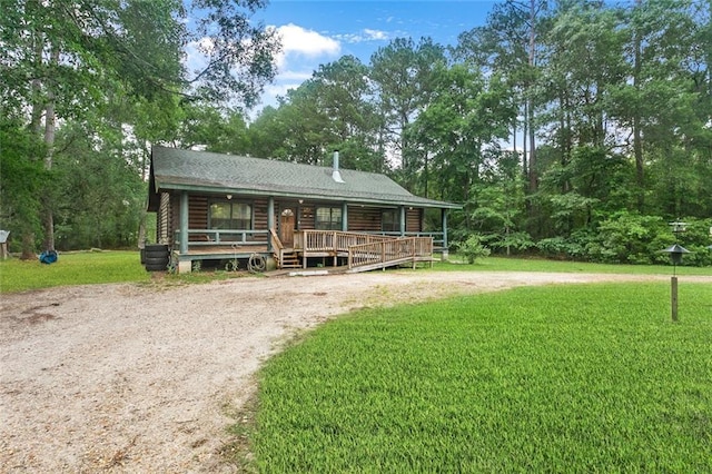 138 Ned Ave, Slidell, LA 70460 - log home with a front lawn, covered porch, dirt driveway, and log siding
