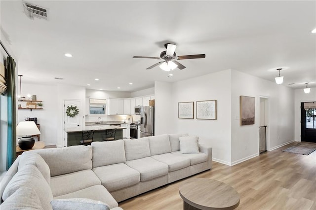 11557 Woodbluff Dr, Covington, LA 70433 - living room featuring a ceiling fan, baseboards, light wood-style floors, and recessed lighting