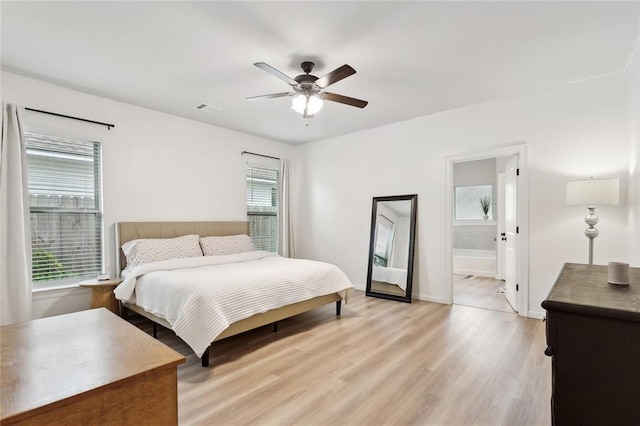11557 Woodbluff Dr, Covington, LA 70433 - bedroom featuring light wood-style floors, baseboards, connected bathroom, and ceiling fan