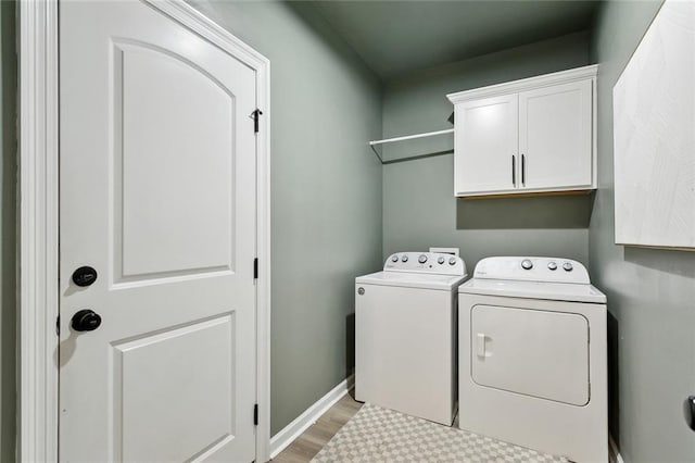 11557 Woodbluff Dr, Covington, LA 70433 - washroom featuring independent washer and dryer, cabinet space, light wood finished floors, and baseboards