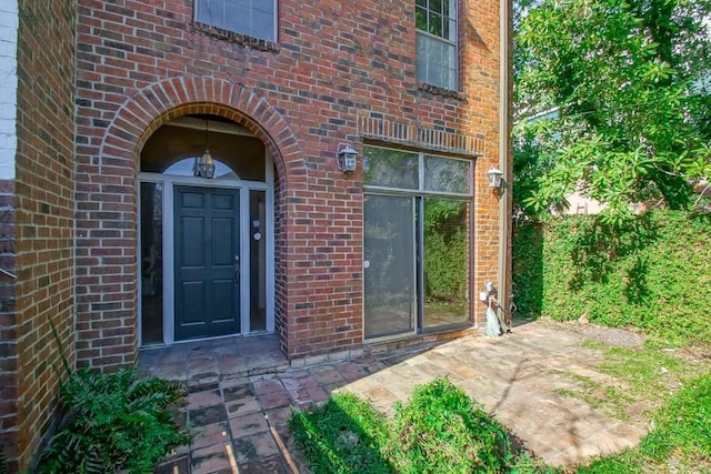 1032 7th St, New Orleans, LA 70115 - property entrance featuring brick siding and a patio