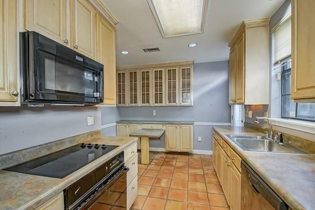 1032 7th St, New Orleans, LA 70115 - kitchen with black appliances, recessed lighting, glass insert cabinets, light brown cabinetry, and light tile patterned flooring
