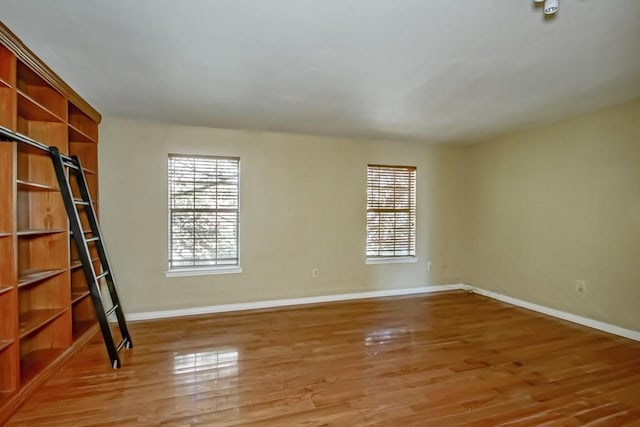 1032 7th St, New Orleans, LA 70115 - spare room featuring baseboards and light wood-style flooring