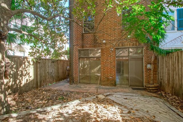 1032 7th St, New Orleans, LA 70115 - fenced backyard with a patio area