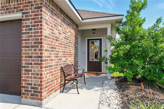 23406 Ruger Dr, Denham Springs, LA 70726 - property entrance with brick siding, a garage, and a shingled roof