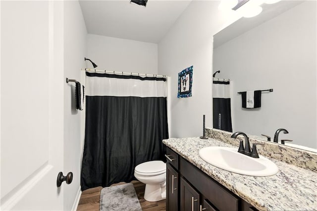 23406 Ruger Dr, Denham Springs, LA 70726 - bathroom with vanity, toilet, curtained shower, and wood finished floors