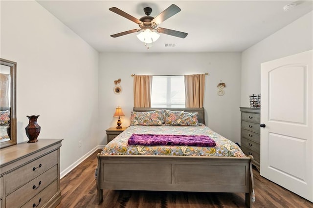 23406 Ruger Dr, Denham Springs, LA 70726 - bedroom featuring dark wood-style flooring, a ceiling fan, and baseboards