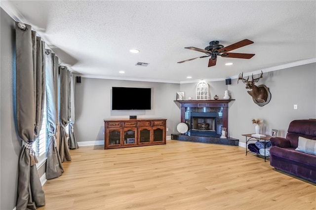 4633 Glendale St, Metairie, LA 70006 - living room featuring light wood finished floors, a ceiling fan, a high end fireplace, ornamental molding, and recessed lighting