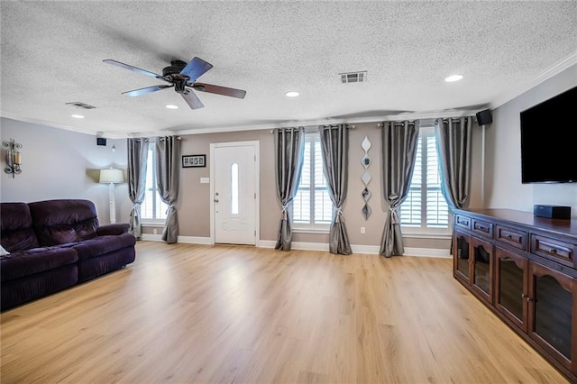 4633 Glendale St, Metairie, LA 70006 - living room with light wood-style floors, a textured ceiling, crown molding, recessed lighting, and a ceiling fan