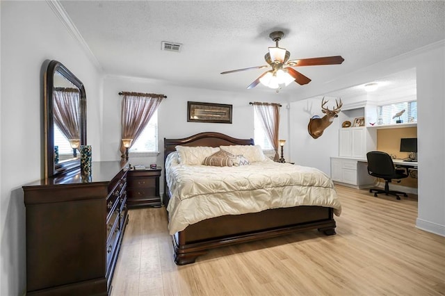 4633 Glendale St, Metairie, LA 70006 - bedroom with crown molding, a textured ceiling, multiple windows, light wood-type flooring, and an office area