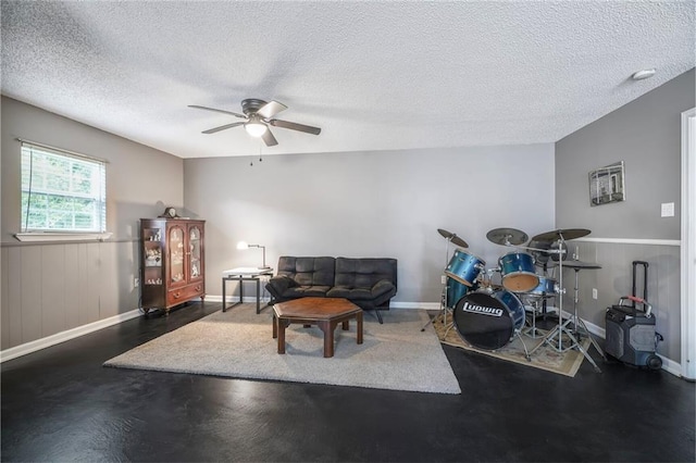 4633 Glendale St, Metairie, LA 70006 - living room with ceiling fan, a textured ceiling, baseboards, and wainscoting
