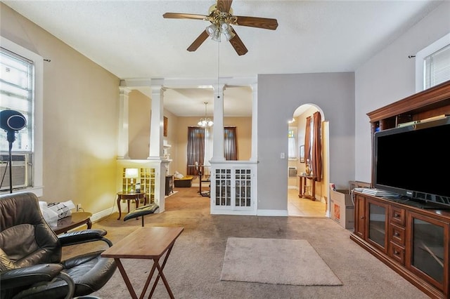 925 N Prieur St, New Orleans, LA 70116 - living area with a ceiling fan, arched walkways, carpet, baseboards, and ornate columns