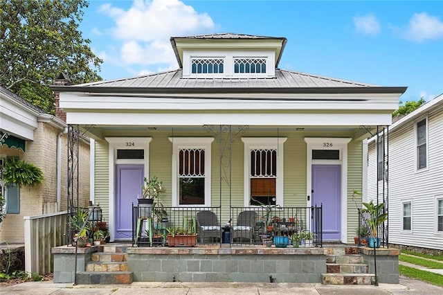 324 Angela St, Arabi, LA 70032 - view of front of home featuring a porch, metal roof, and a standing seam roof