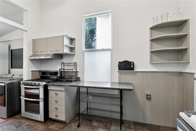 324 Angela St, Arabi, LA 70032 - kitchen with washing machine and dryer, range with two ovens, under cabinet range hood, open shelves, and gray cabinets