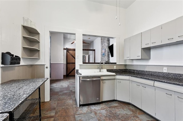 324 Angela St, Arabi, LA 70032 - kitchen with stainless steel dishwasher, a ceiling fan, dark stone finish floors, and a sink