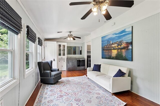 324 Angela St, Arabi, LA 70032 - living area with washer and dryer, vaulted ceiling, wood finished floors, and ceiling fan