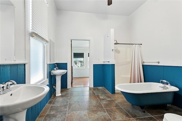 324 Angela St, Arabi, LA 70032 - full bathroom with a freestanding tub, a sink, stone finish flooring, and toilet