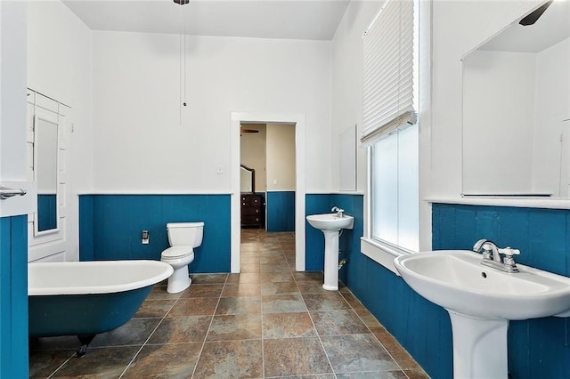 324 Angela St, Arabi, LA 70032 - full bathroom with a soaking tub, stone finish floors, toilet, a sink, and a towering ceiling