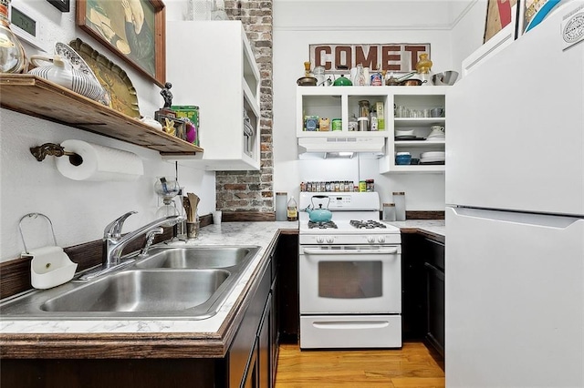 324 Angela St, Arabi, LA 70032 - kitchen with white appliances, open shelves, under cabinet range hood, a sink, and light wood-type flooring