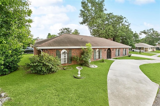 1500 Hudson St, Kenner, LA 70062 - ranch-style home with brick siding, a front yard, concrete driveway, and roof with shingles