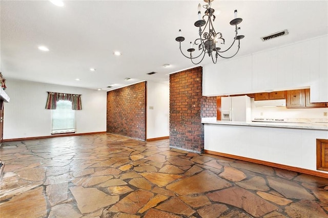 1500 Hudson St, Kenner, LA 70062 - unfurnished living room featuring stone floors, recessed lighting, a chandelier, and baseboards