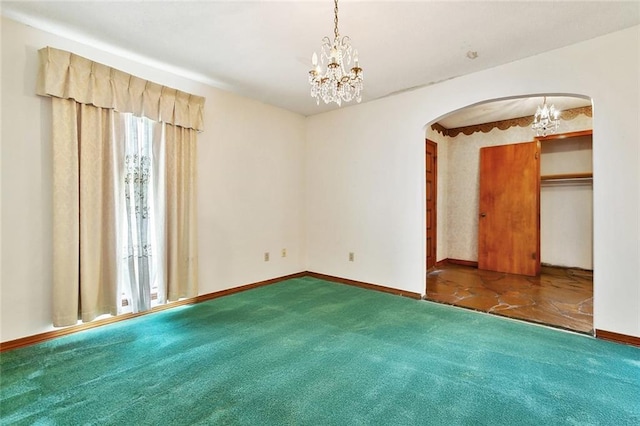 1500 Hudson St, Kenner, LA 70062 - carpeted spare room with arched walkways, a chandelier, and baseboards