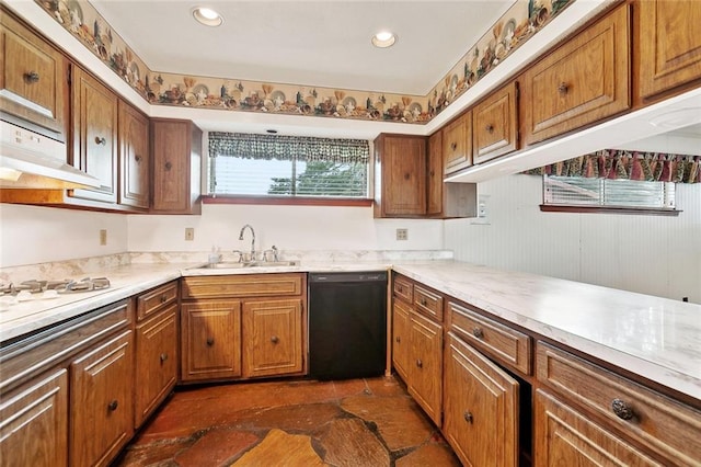 1500 Hudson St, Kenner, LA 70062 - kitchen with black dishwasher, a sink, brown cabinets, light countertops, and dark stone finish flooring