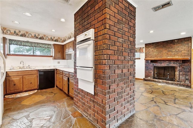 1500 Hudson St, Kenner, LA 70062 - kitchen featuring black dishwasher, stone flooring, white oven, a sink, and recessed lighting