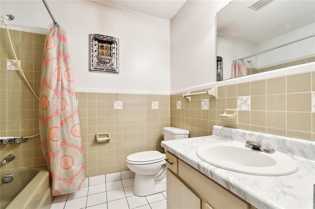 1500 Hudson St, Kenner, LA 70062 - full bathroom featuring vanity, tile walls, tile patterned flooring, shower / bath combo, and toilet