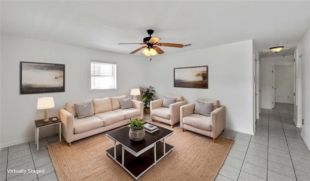 2112 Munster Blvd, Meraux, LA 70075 - living room with light tile patterned floors, attic access, ceiling fan, and baseboards