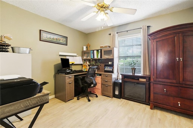 7045 River Rd, Waggaman, LA 70094 - home office featuring light wood-type flooring, ceiling fan, and a textured ceiling