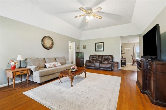 7045 River Rd, Waggaman, LA 70094 - living room with a ceiling fan, wood finished floors, baseboards, and a raised ceiling