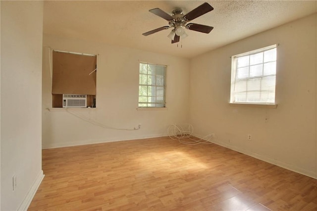 461214 Grammar Ave, Metairie, LA 70001 - empty room featuring wood finished floors, a ceiling fan, baseboards, cooling unit, and a textured ceiling