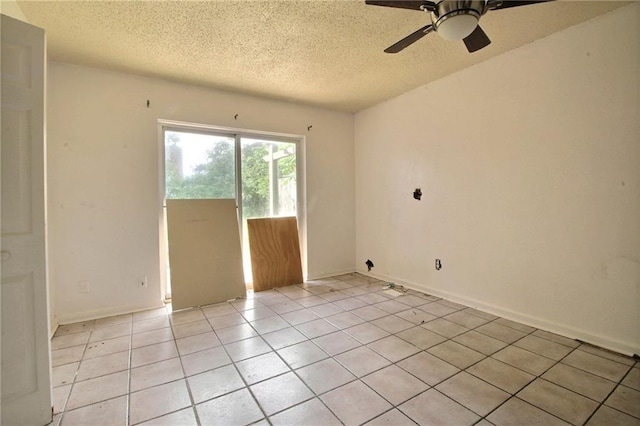 461214 Grammar Ave, Metairie, LA 70001 - spare room with a textured ceiling, a ceiling fan, light tile patterned flooring, and baseboards