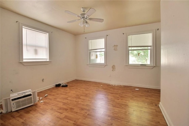 461214 Grammar Ave, Metairie, LA 70001 - unfurnished room with light wood-style floors, ceiling fan, baseboards, and a wall mounted AC