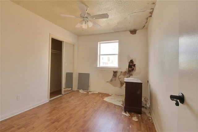 461214 Grammar Ave, Metairie, LA 70001 - unfurnished bedroom with wood finished floors, baseboards, a ceiling fan, and a textured ceiling