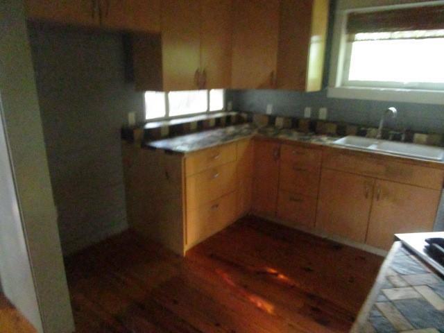 6561 Catina St, New Orleans, LA 70124 - kitchen with a sink, wood finished floors, and light countertops